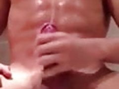 Oiled hard cock solo boy jizzes big load on abs