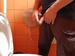 Pissing in an orange public toilet