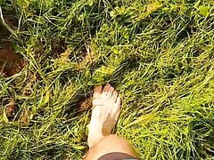 Master Ramon takes off his sweaty shoes and socks and walks barefoot through the damp grass