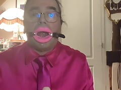 In fuchsia flight attendant's outfit for one evening with a mouth retractor