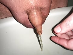 play with my small foreskin cock while pissing