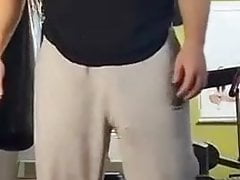 Guy at gym lifting weights huge bulge in grey trackies