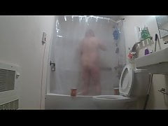 taking a shower through clear curtain