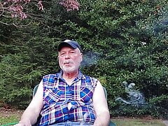 Gardener dad moving plants, then takes a break for a smoke