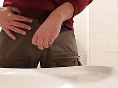 Pissing in a public toilet sink
