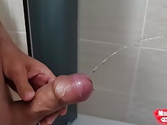 Erection cock pissing in the bathroom