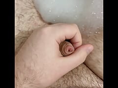 Chubby guy with tight foreskin wanks in the bath with cumshot